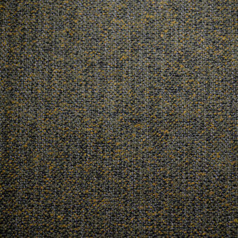 Agata fabric sample by Bolzan Letto, dark charcoal gray woven textile with speckled golden yellow flecks and a looped, granular texture.
