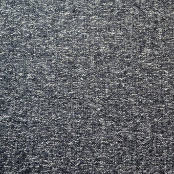 Woven fabric sample, dark gray and white flecks, tight granular texture with subtle directional pattern, matte finish.