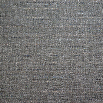 Woven fabric sample, muted gray with heathered texture, speckled with yellow, blue, and white; label reads “bolzan letti azalea 114”.