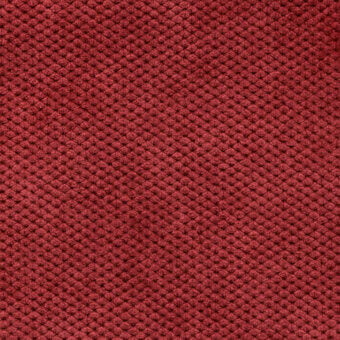 Reddish-brown velvet fabric texture features a dense, repeating circular pattern with a subtly nubby surface and uniform coloration.