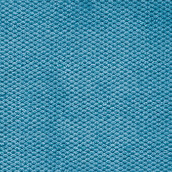 Turquoise velvet fabric texture with repeating raised circular pattern, dense pile, and uniform color, Bolzan Letto collection sample.