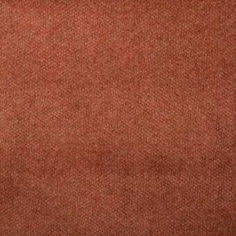 Terracotta fabric sample with dense granular texture, woven plain material in rusty orange tone, even lighting highlights surface variations.