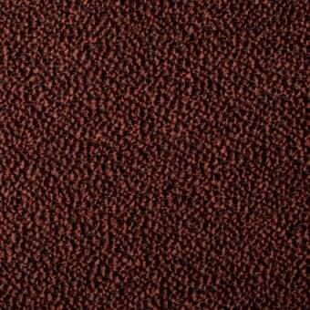 Woven fabric texture in reddish-brown with dark flecks, exhibiting a granular, nubby surface and uneven plane; studio lighting.