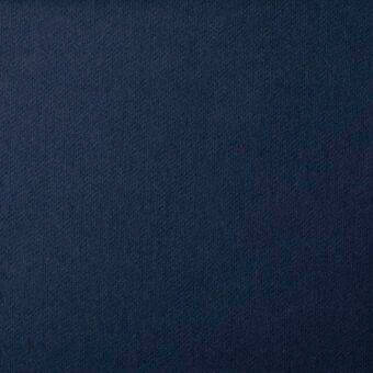 Navy blue woven fabric texture, Bonaldo St Moritz MC80, dense matte wool blend with granular surface and visible product label.