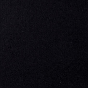 Black fabric texture with a granular, dense pile and woven construction, displaying subtle tonal variations against a dark background.