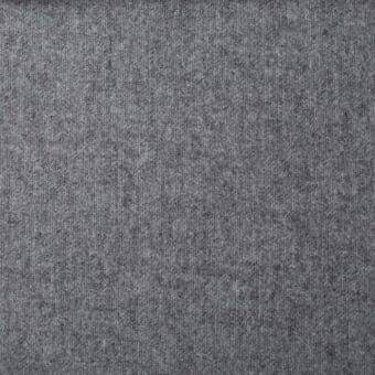 Gray woven fabric texture with vertical ribbing, heathered tonal variations, and matte finish; label reads “st moritz mc87” from Bonaldo fabrics.