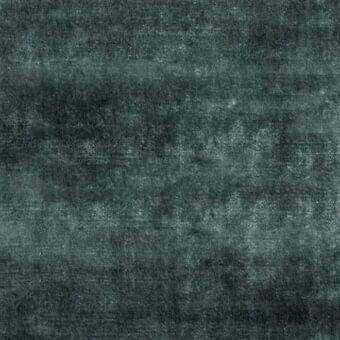 Teal woven fabric sample displaying horizontal striations and a matte finish, with a dense granular texture against a neutral backdrop.
