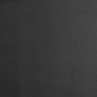 Black leather texture displaying a matte finish, irregular grain, and subtle wrinkles against a neutral backdrop, showing a dense, porous surface.