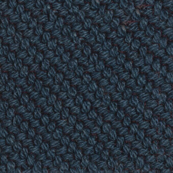 Denim blue woven fabric texture with looped yarns, exhibiting a nubby knit structure and subtle reddish-brown thread details; Kvadrat Coda tkc06.