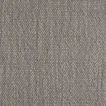 Gray nubby fabric texture, Suvereto g307, with small raised circles and faint vertical weave lines in diffused lighting.