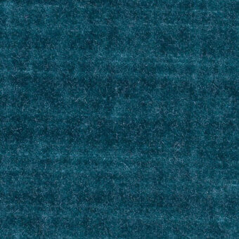 Teal velvet fabric sample displaying a dense, short pile texture with tonal variations and subtle shading across the surface.