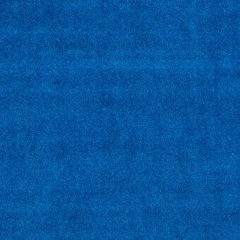 Blue velvet fabric sample displaying a dense, short pile texture and matte finish, with a subtly granular surface quality.
