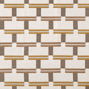 Geometric fabric pattern with interlocking off-white, brown, and gray rectangles accented by thin gold horizontal threads and a woven texture.