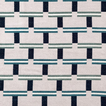 Geometric textile pattern with staggered navy, teal, and beige rectangular blocks on a light beige woven background, matte finish.