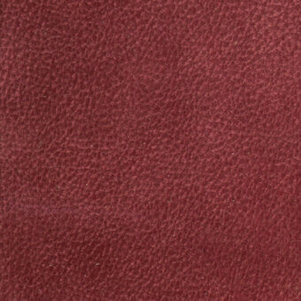 Burgundy leather texture with granular surface, brushed finish, and subtle tonal variations; displays sparse light fibers and mottled appearance.