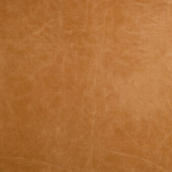 Honey leather texture sample displaying a mottled surface with fine creases, a matte finish, and warm brown color variations.