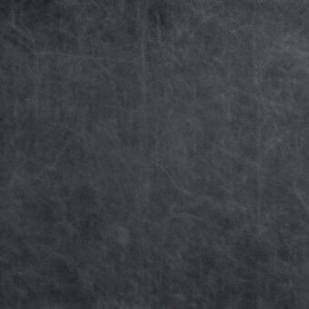 Dark grey leather texture with a mottled surface, irregular grain, and matte finish displaying a petrolio hue and nuanced visual depth.