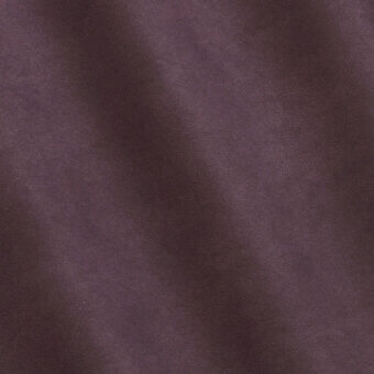 Plum suede texture with granular nap, exhibiting diffused lighting and a matte finish, presenting a consistent, uniform surface.