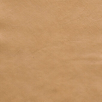 Tan leather texture with a fine, pebbled grain and mottled tone, displaying a matte finish and natural hide appearance.