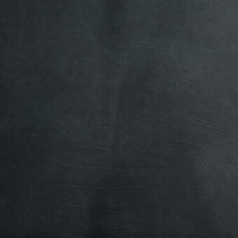 Dark gray leather texture with pronounced grain, matte finish, and subtle tonal variations suggesting vegetable tanning and a distressed, aged appearance.