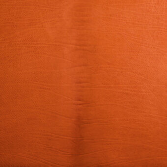 Orange vegetable-tanned leather texture displays vertical grain, matte finish, and subtle wrinkles; labeled “waterfall (vegetable tanned).”