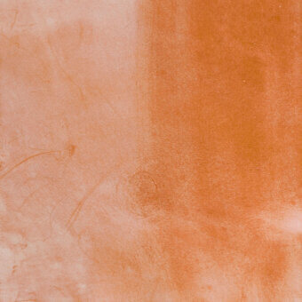 Textured gradient surface displaying blush to terracotta tones, with porous clay-like texture and subtle linear striations throughout.
