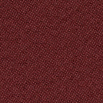 Red fabric texture sample, granular surface, matte finish, col. 64203, densely packed particles, uneven and warm tactile quality.