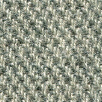 Heathered gray and off-white woven fabric texture with nubby loops, likely wool-blend, displaying textile code “bross > fabric (b) molly > col. 114”.