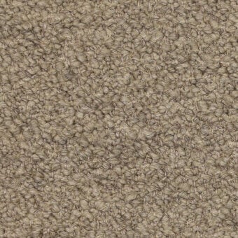 Beige looped pile fabric texture with a matte finish, displaying a nubby surface and subtle mottled variations, plus a printed label.