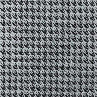 Fabric texture sample, grayscale palette, diagonally oriented repeating pattern of small irregular shapes, woven appearance, possible wool blend.