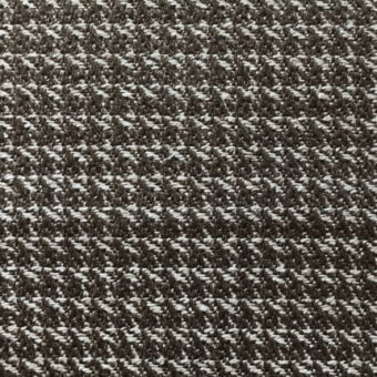 Herringbone fabric texture in dark charcoal gray and off-white, featuring a dense, diagonal weave with a matte finish.