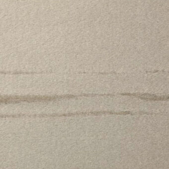 Beige fabric texture with horizontal seams, possibly wool-blend, matte finish; “casa casati” text imprinted at bottom edge, diffused lighting.
