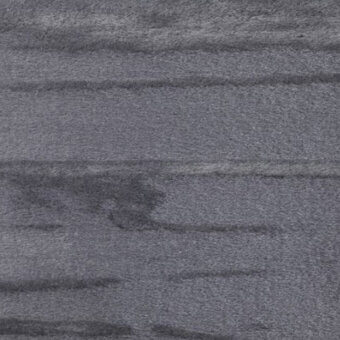Gray casa casati orsetto fabric texture with a dense, velvety pile and subtle horizontal striations, featuring a central circular mark.