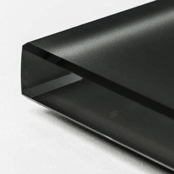 Frosted glass rectangular prism, black painted exterior, sharp edges, minimalist geometric form against a white backdrop.