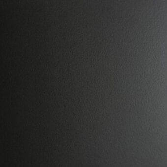 Matte graphite textured wall panel, gradient gray tone, fine granular surface creating depth with diffused, soft lighting.