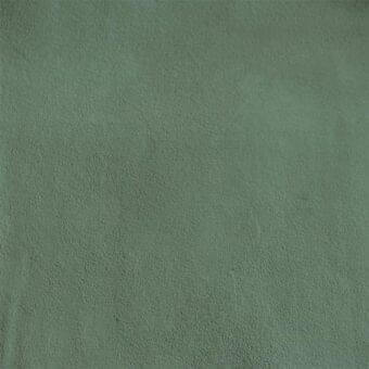 Micro nubuk fabric texture in muted mint green, displaying a matte finish with a subtle, uneven grain and dense, plush weave.