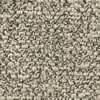 Off-white tweed fabric with speckled gray and black elements, featuring a dense, complex weave and slightly raised fibrous texture.