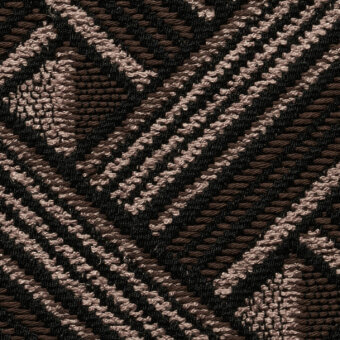 Woven fabric sample, dark brown and beige geometric pattern, diagonal lines and grid structure, textured surface, with “cierre1972” label.