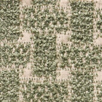Geometric fabric sample with olive green and beige squares in a grid, featuring a dense woven nubby texture and subtle contemporary design.