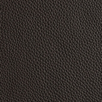 Dark brown leather texture displaying a dense, repeating geometric pattern of small triangles and rhomboids with a matte finish.