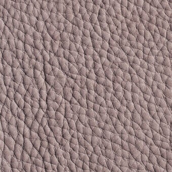 Gray-taupe nubuck leather texture with a dense, irregular bumpy pattern and matte finish, displaying subtle tonal variations within the grain.