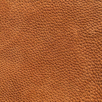 Nubuck leather texture, warm brown, pebble grain; dense pattern with raised bumps, matte finish, natural tonal variations, Cierre1972 sample.