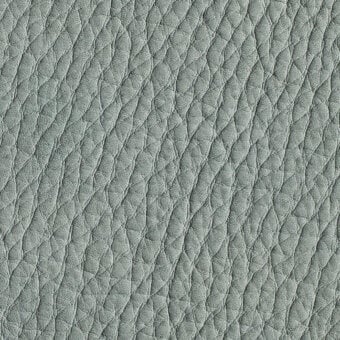 Gray nubuck leather texture with repeating diamond indentations in horizontal rows, exhibiting a matte finish and natural grain variations.