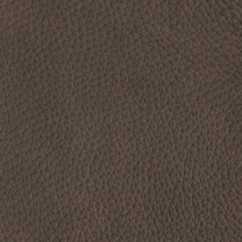 Brown nubuck leather texture with a dense, irregular pattern of raised bumps and subtle creases, displaying a warm, matte finish.