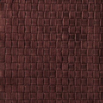 Brown leather texture with a quilted rectangular grid pattern, displaying natural grain and a matte, distressed finish.