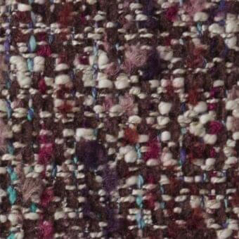 Brown tweed fabric sample with irregular weave, burgundy, purple, cream, and turquoise flecks, textured nubby surface, Constantini Pietro label.