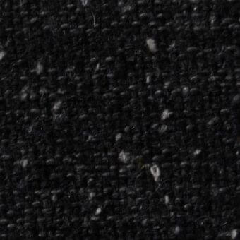 Charcoal gray woven fabric texture, speckled with off-white flecks, dense nubby weave, matte finish, from Constantini Pietro fabrics collection.
