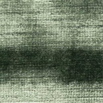 Green fabric sample displaying a horizontal gradient from silvery-green to forest green, with a visible, nubby woven texture and product label.