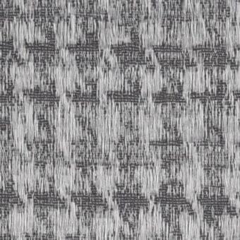 Woven fabric texture in grayscale tones features irregular horizontal and vertical threads, creating a dense, fragmented pattern with varied density.