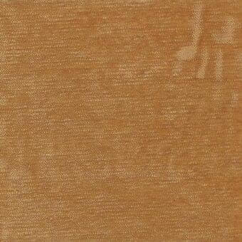 Fabric sample, golden-brown linen weave, textured matte surface with subtle tonal variations and distressed markings; label reads “ditre italia”.